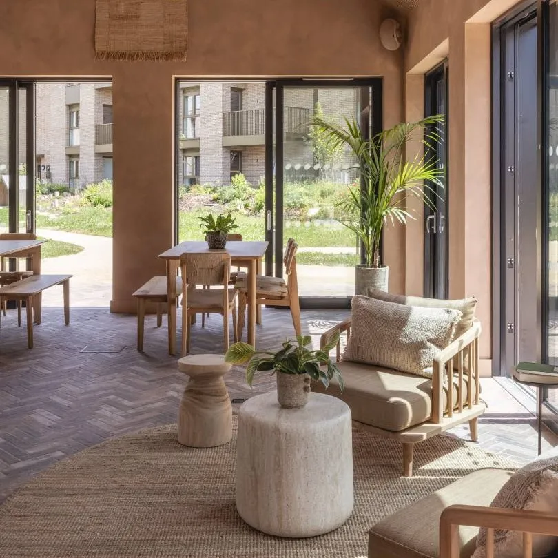 Bright space with wooden chairs, soft chairs and large windows
